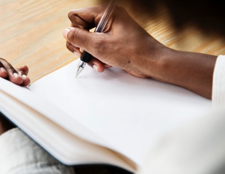 woman writing in notebook image