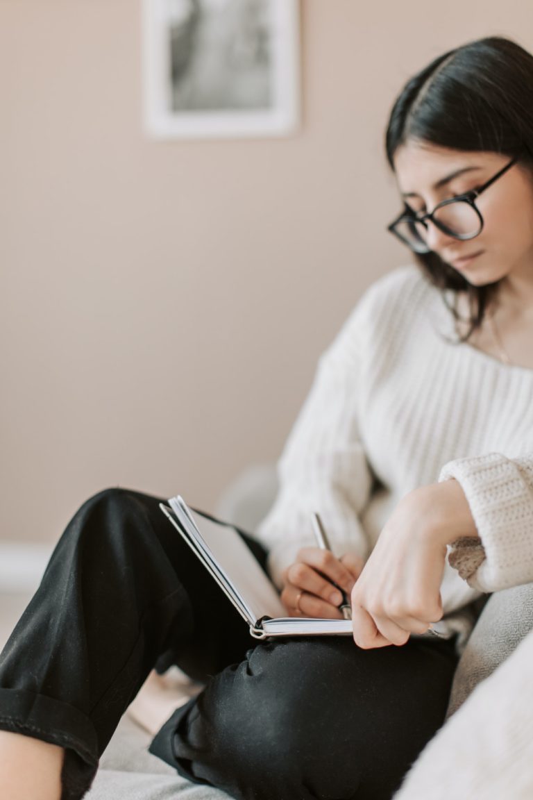 woman writing in journal image