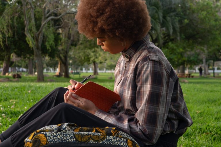 woman writing in notebook image