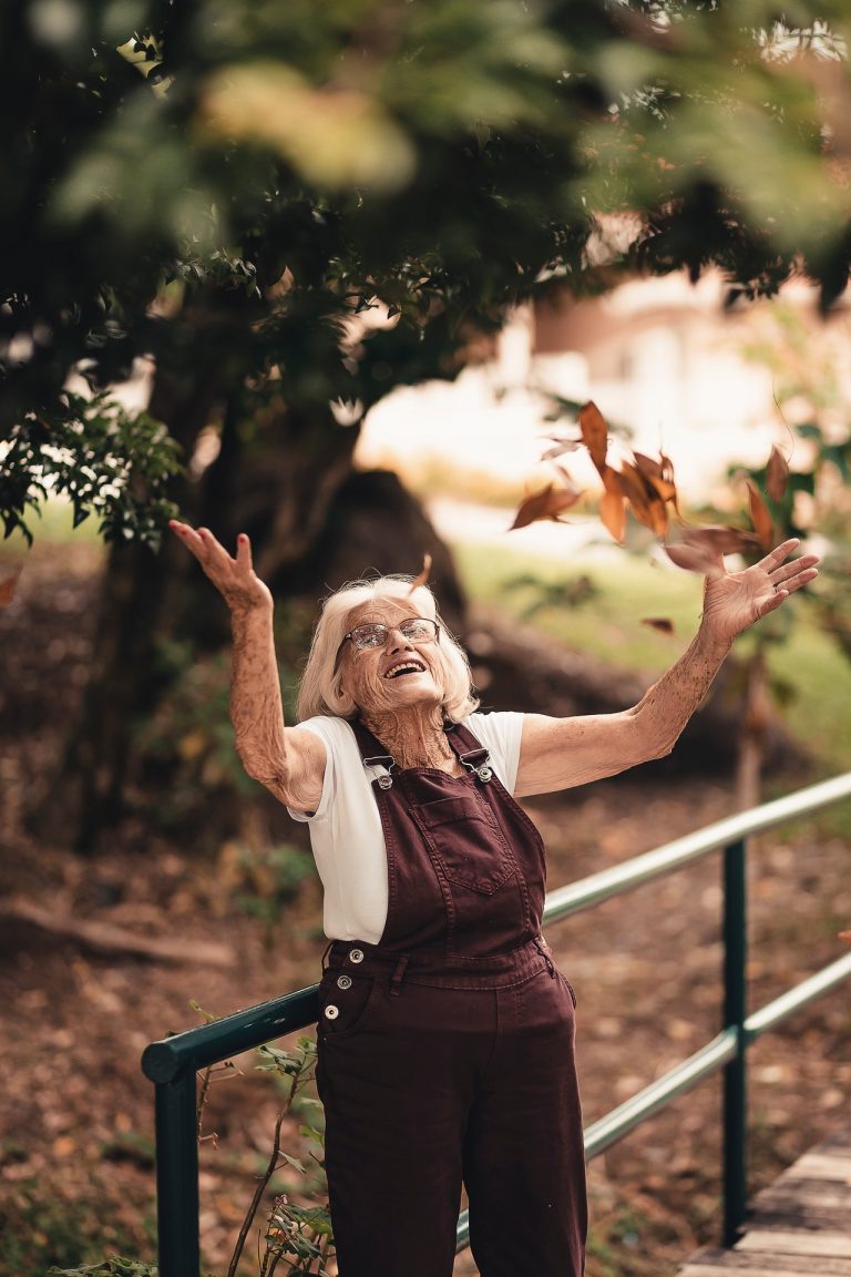 character strength-elderly woman playing with leaves