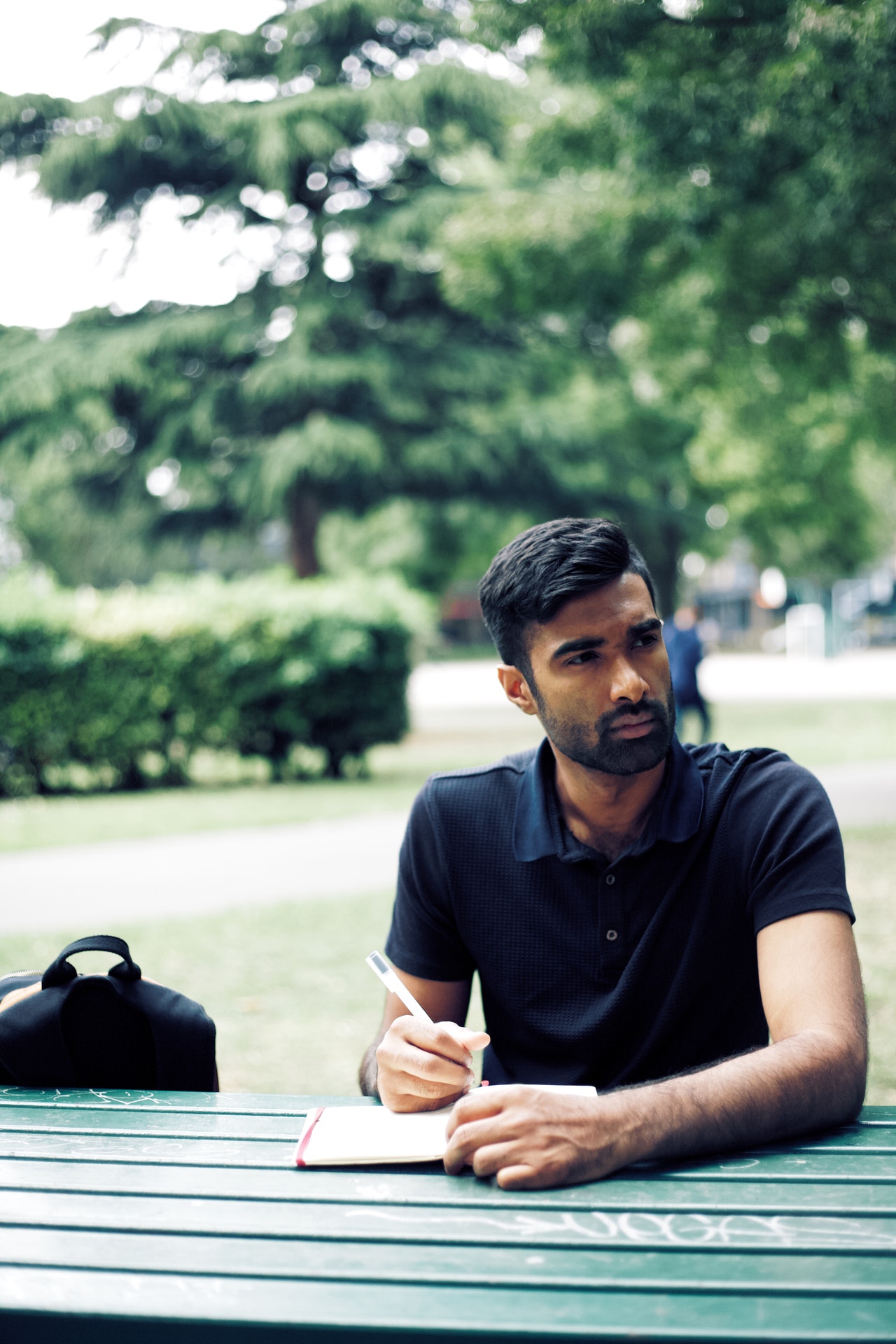 man writing in park