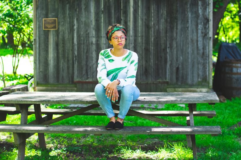 woman sitting on picnic table